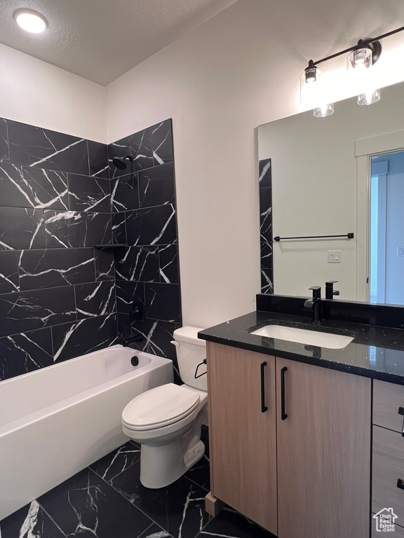 Bathroom with marble finish flooring, toilet, vanity, and tub / shower combination