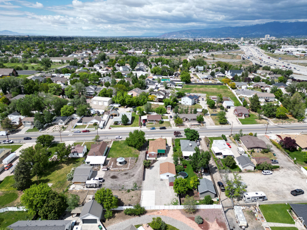 Aerial overview of property\'s location featuring nearby suburban area and a mountainous background