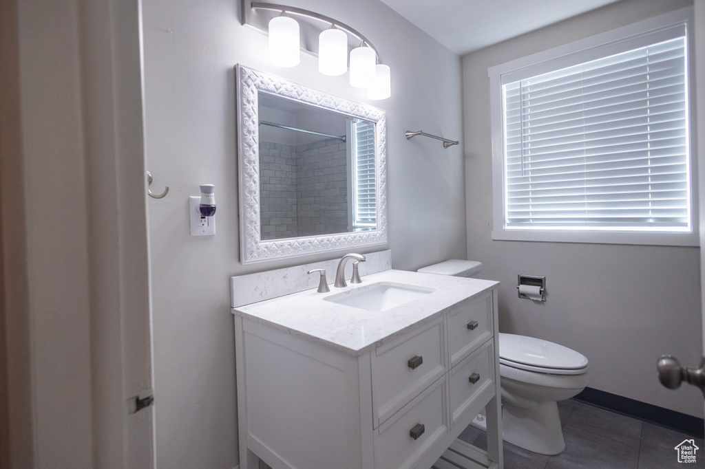 Full bath with toilet, vanity, a shower, and tile patterned floors