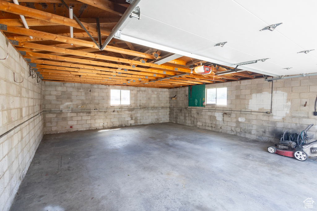 Garage with a garage door opener and concrete block wall