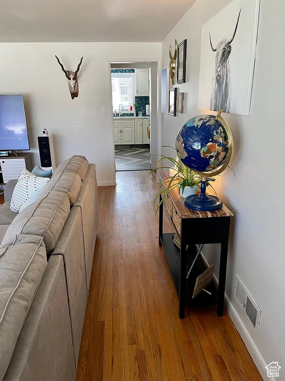 Living area with dark wood finished floors and baseboards