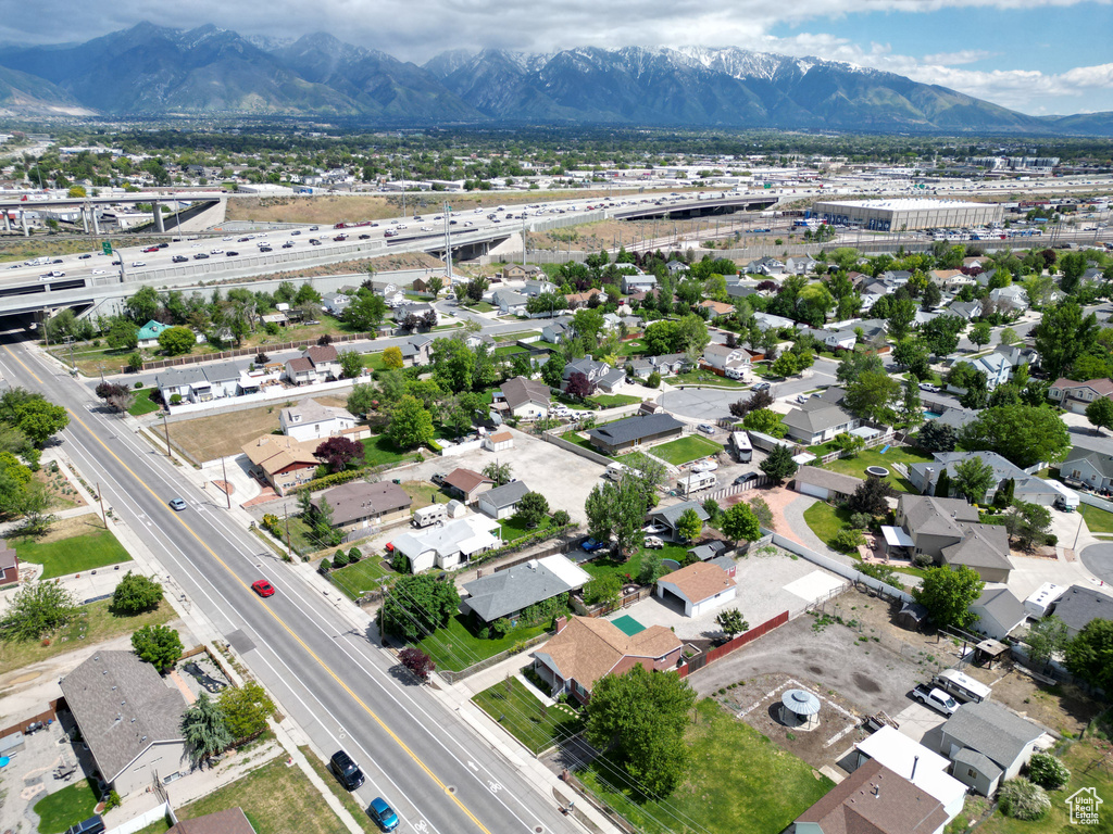 Aerial perspective of suburban area featuring a main thoroughfare and mountains
