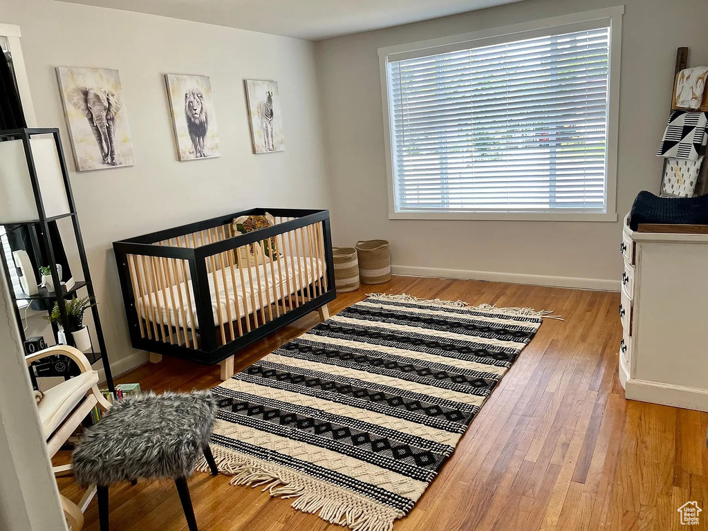 Bedroom with wood finished floors and baseboards