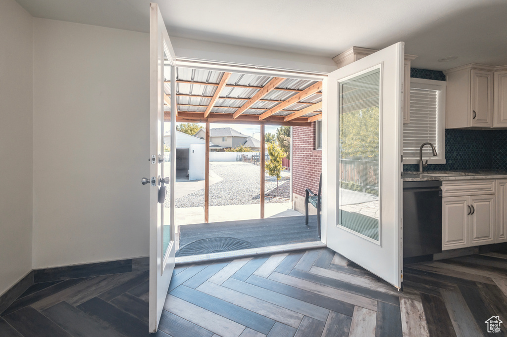 Doorway with a sink, baseboards, and french doors