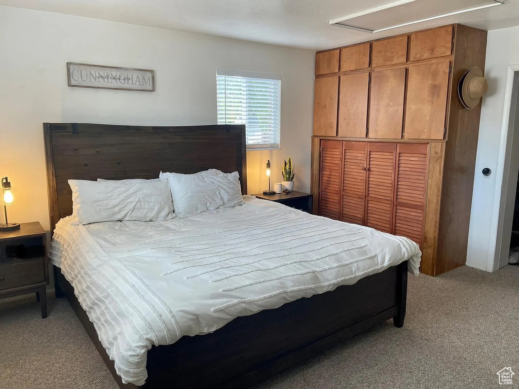 Bedroom featuring light colored carpet