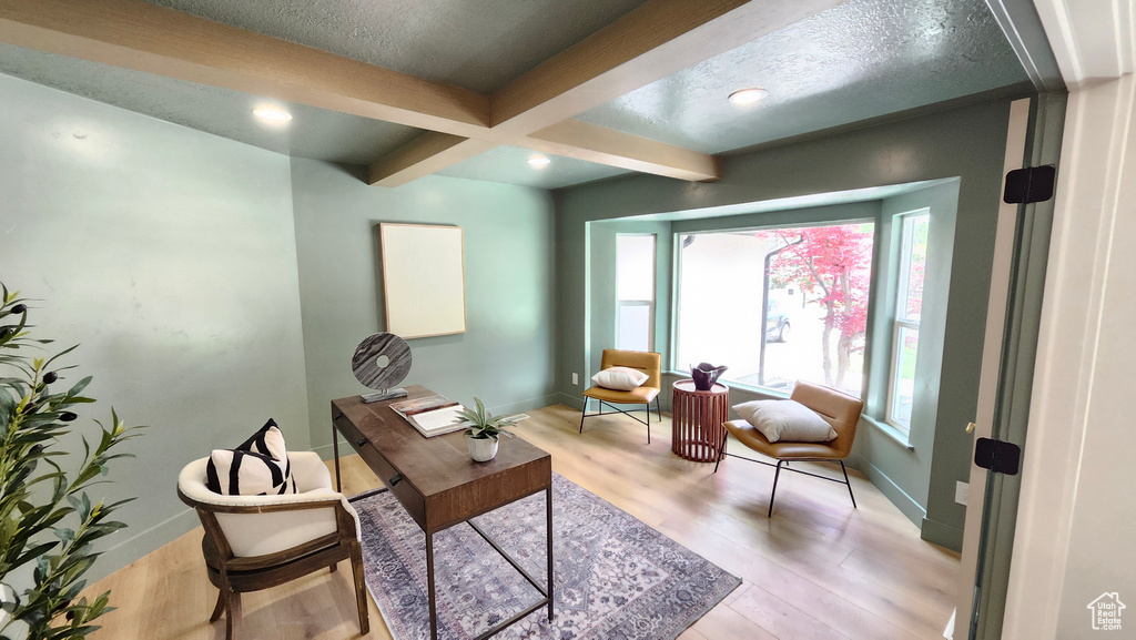 Home office featuring beam ceiling, baseboards, light wood-style floors, a textured ceiling, and recessed lighting