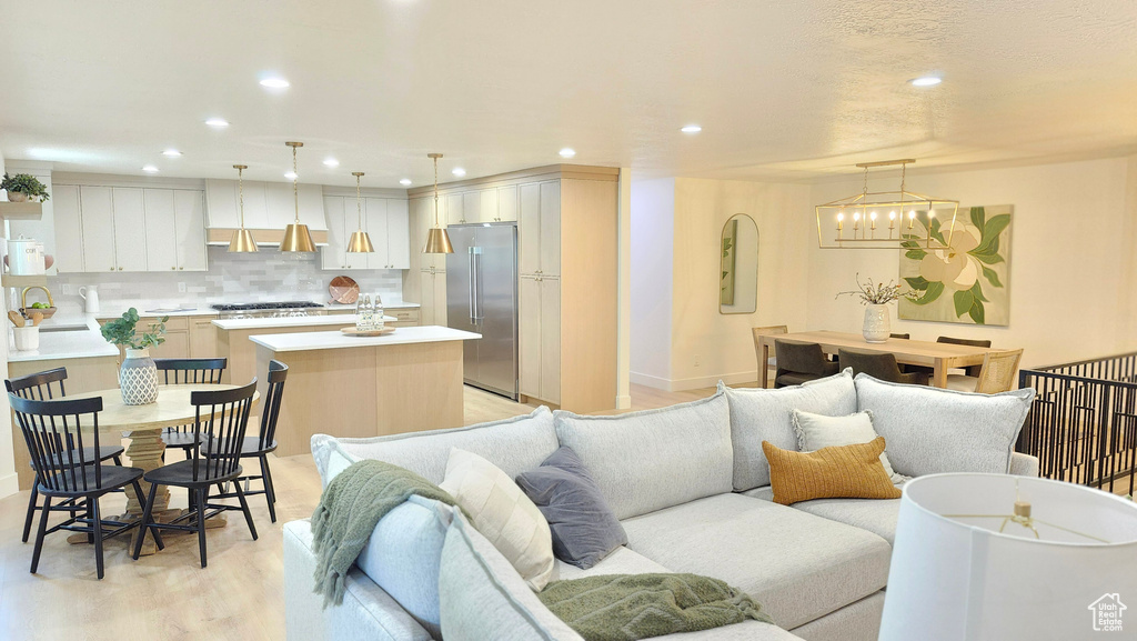 Living room featuring recessed lighting, light wood finished floors, and baseboards