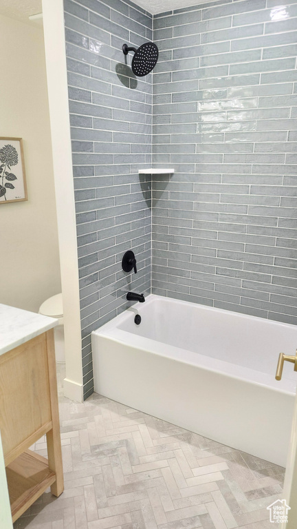 Full bathroom with bathing tub / shower combination, vanity, and toilet