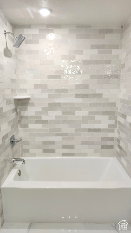 Bathroom featuring washtub / shower combination