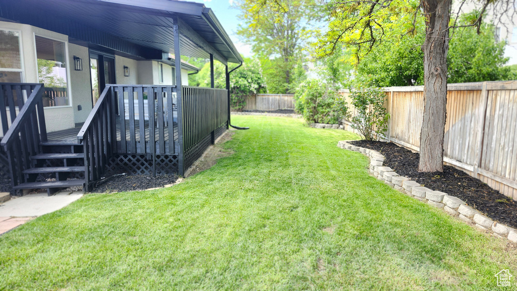 View of yard featuring a wooden deck