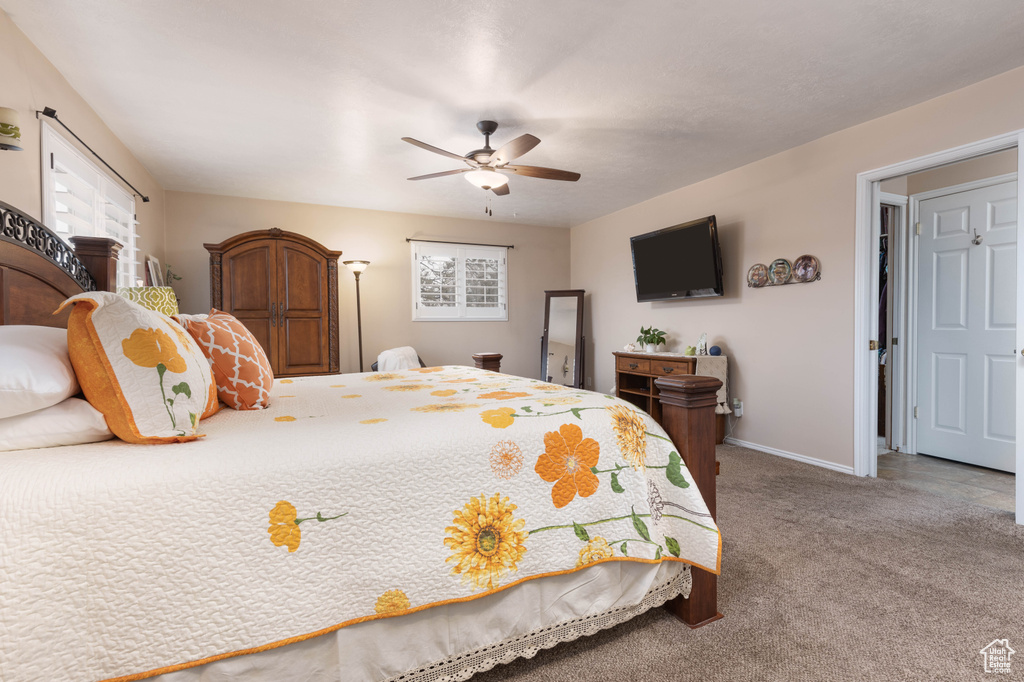 Bedroom with carpet, baseboards, and ceiling fan