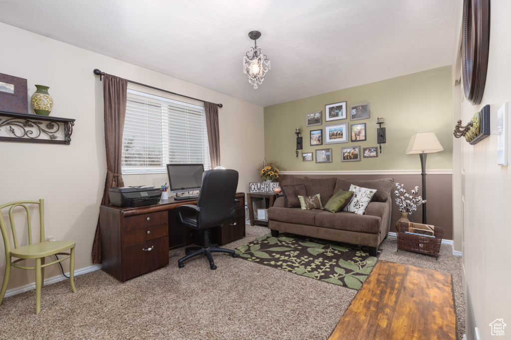 Carpeted office space with baseboards