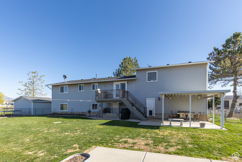 Back of house featuring stairway, a patio area, and a wooden deck