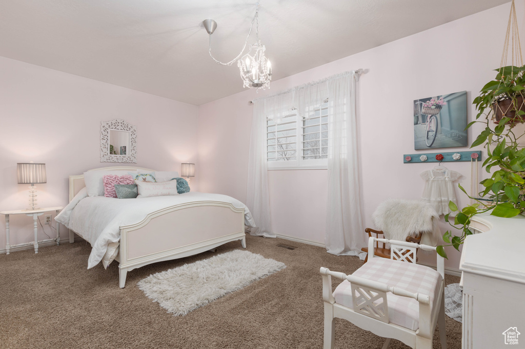 Carpeted bedroom with a chandelier