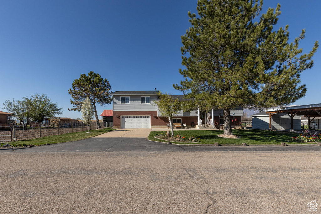 Tri-level home with asphalt driveway and a garage