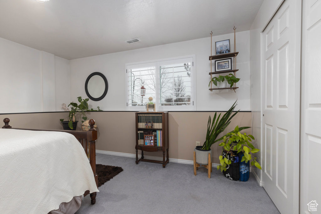 Carpeted bedroom featuring baseboards