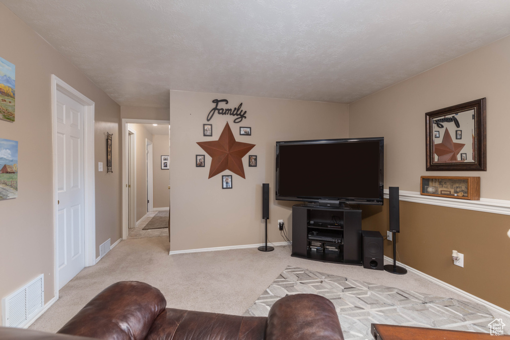 Carpeted living room featuring baseboards