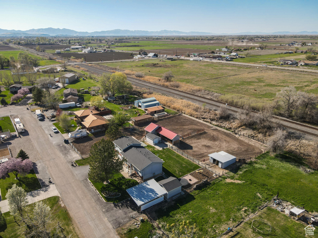 Aerial view of property and surrounding area with rural landscape and a mountain backdrop