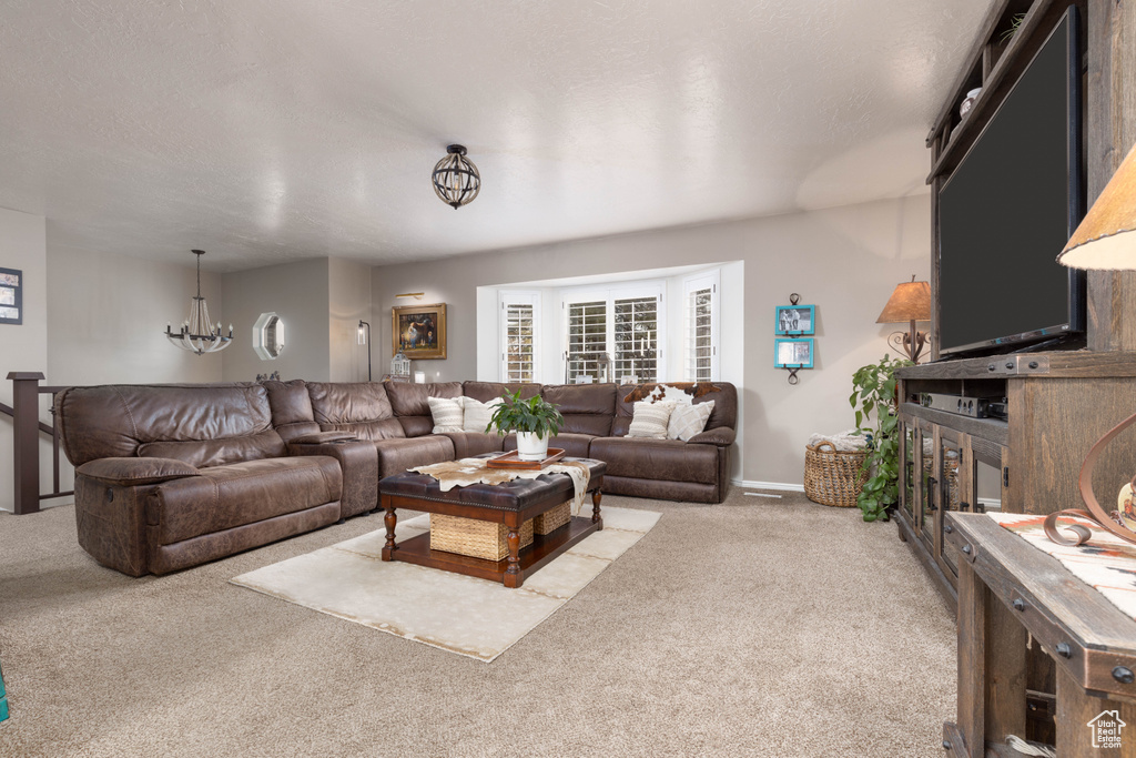 Living area with carpet and a chandelier