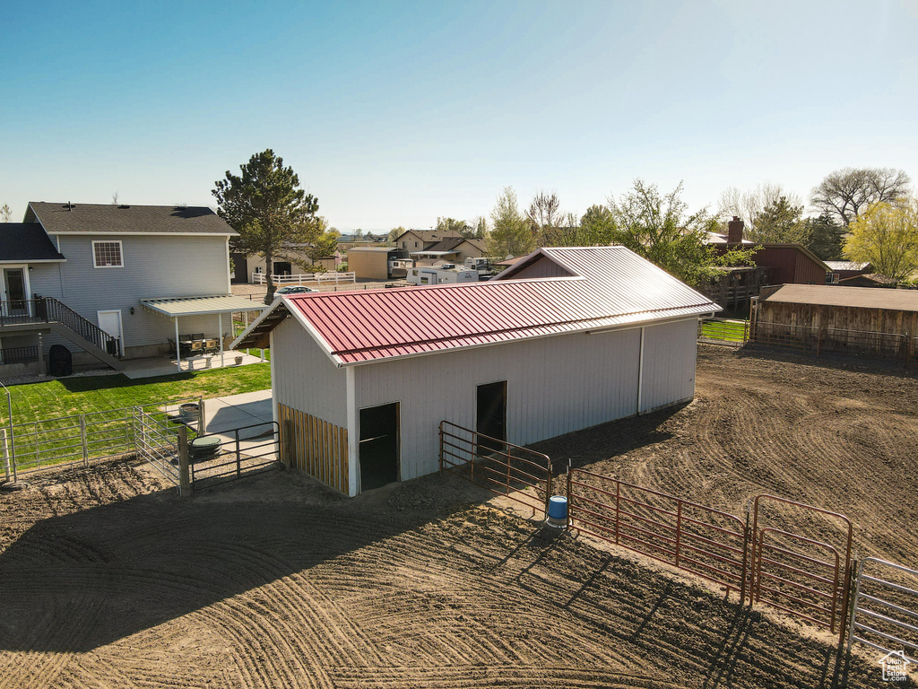 View of side of home with an exterior structure, metal roof, an outbuilding, and a standing seam roof