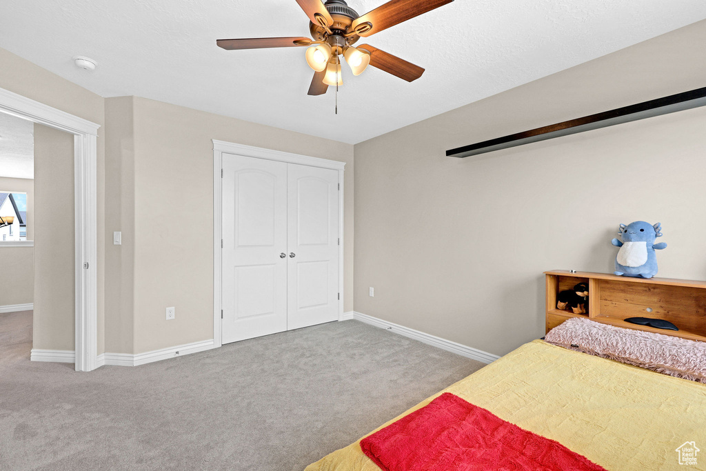 Bedroom featuring carpet, baseboards, and a ceiling fan