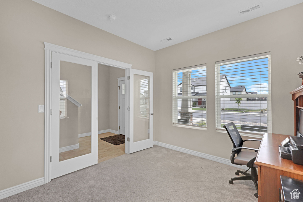 Office area featuring french doors, carpet flooring, and baseboards
