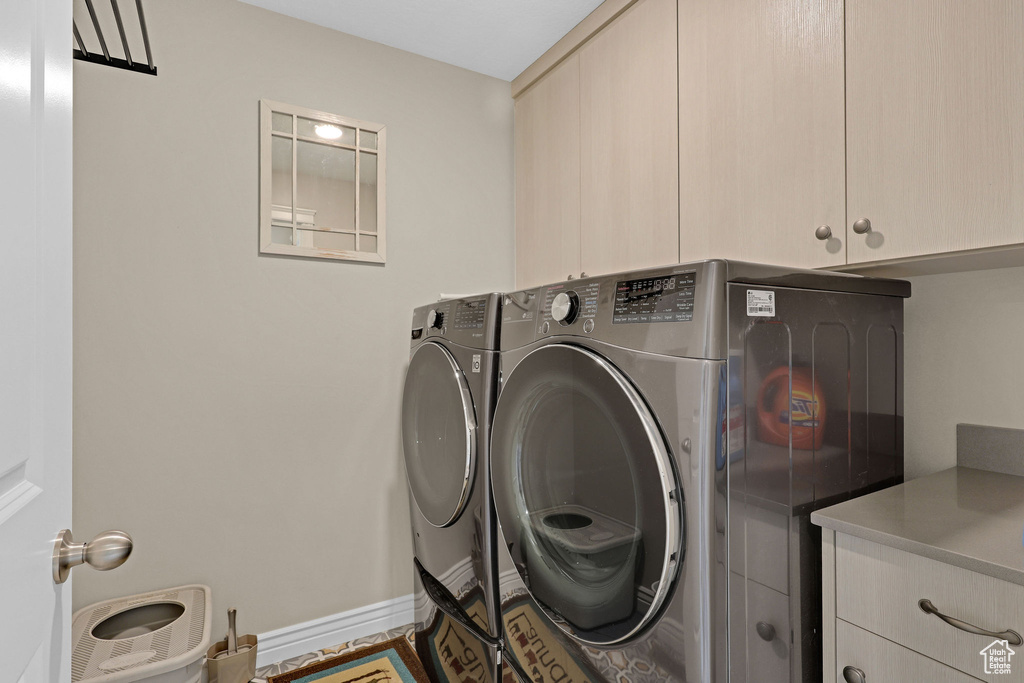 Laundry area featuring cabinet space and washer and dryer