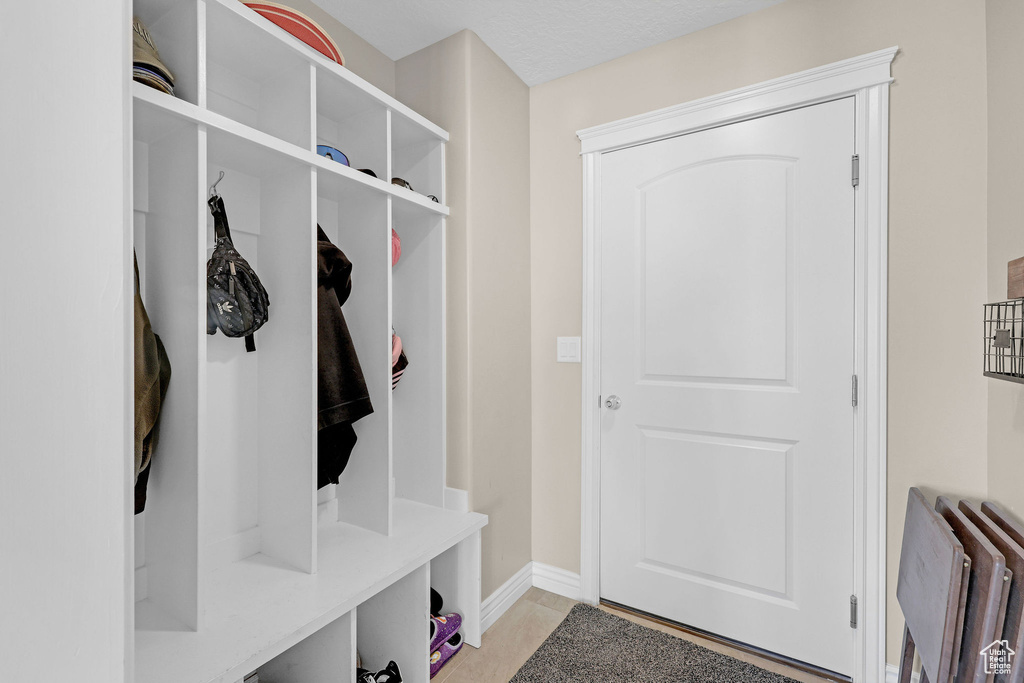 Mudroom with radiator heating unit and baseboards
