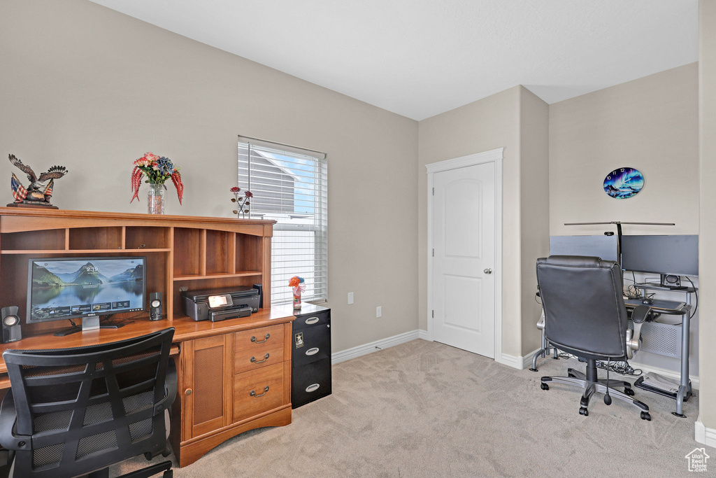 Office space with baseboards and light colored carpet