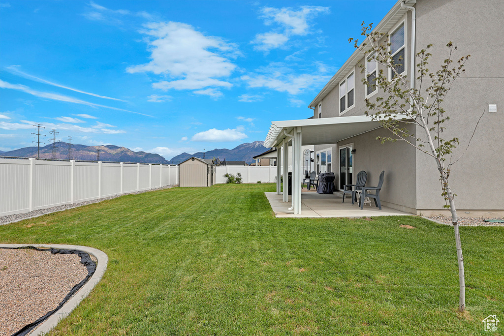 View of yard featuring a mountain view and a patio area
