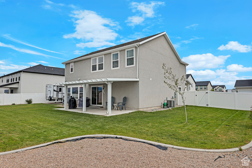 Back of property featuring a pergola, a gate, stucco siding, and a patio