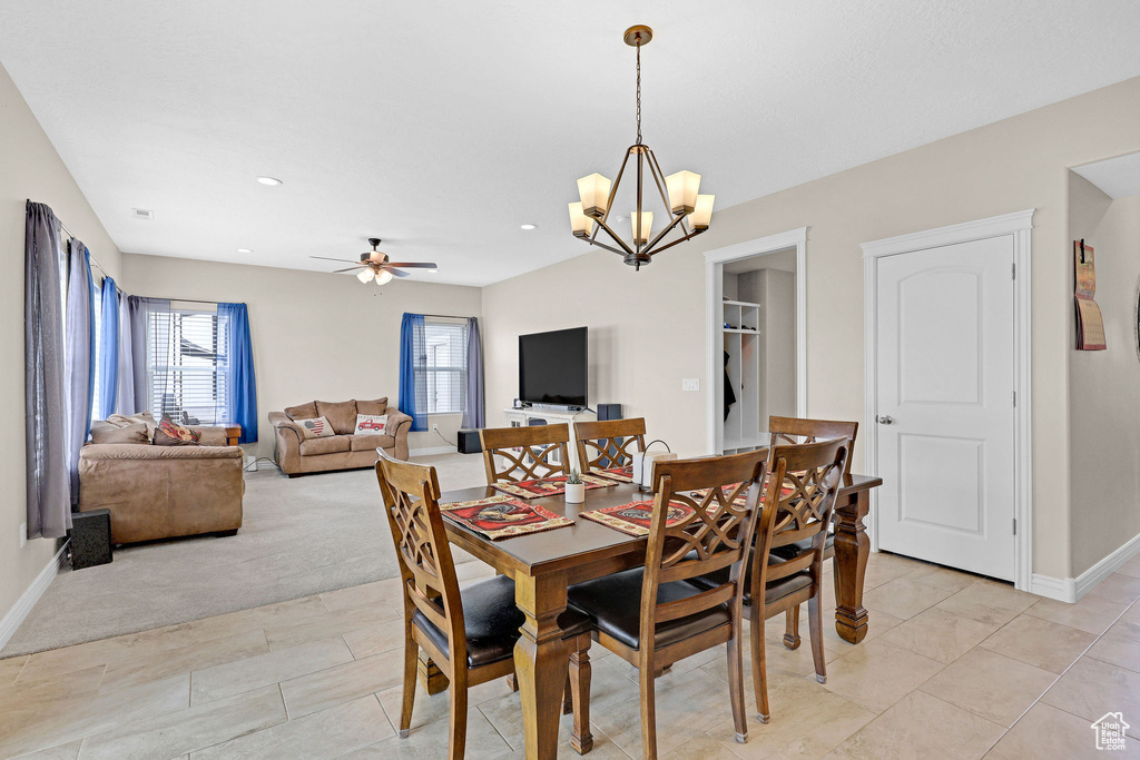 Dining space featuring a chandelier, baseboards, a ceiling fan, light tile patterned flooring, and recessed lighting