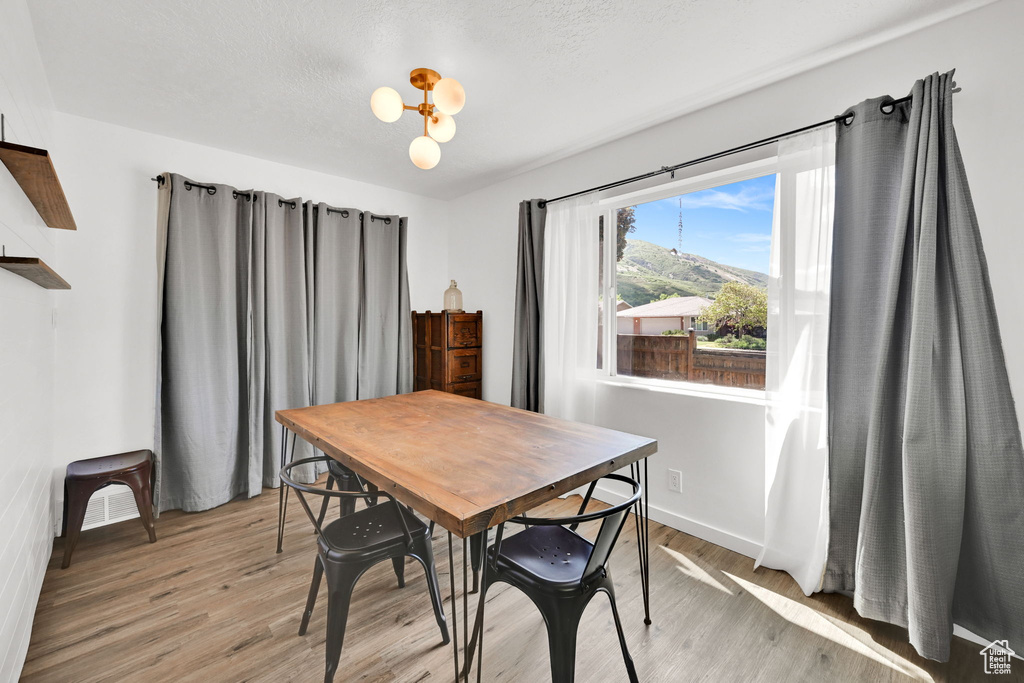 Dining space with light wood finished floors and baseboards