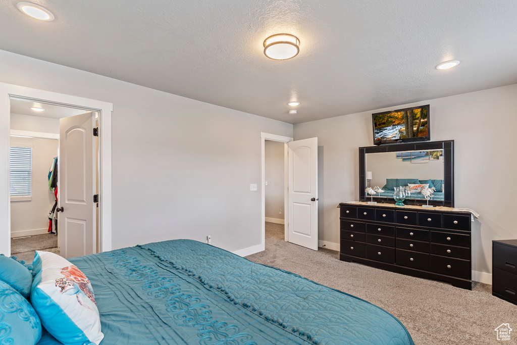 Carpeted bedroom featuring baseboards and recessed lighting