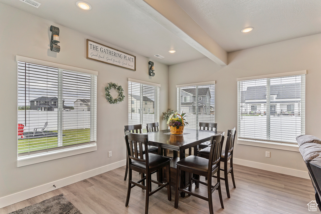 Dining space featuring baseboards, light wood-style flooring, and recessed lighting