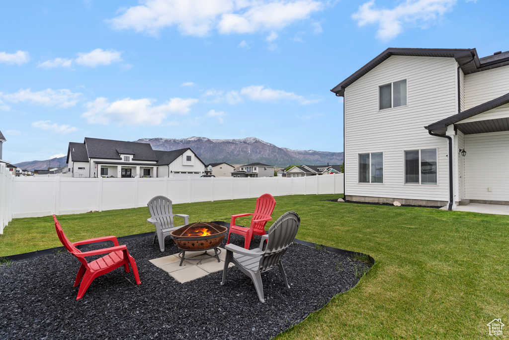 View of yard with a fire pit and a mountain view