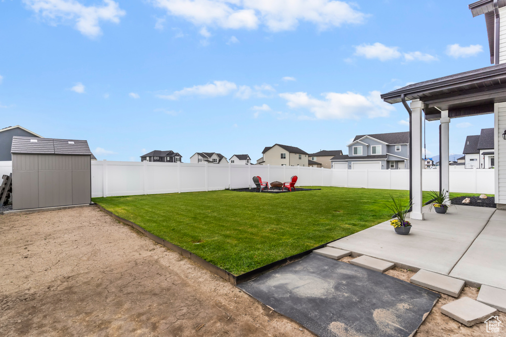 View of yard featuring a patio and a residential view