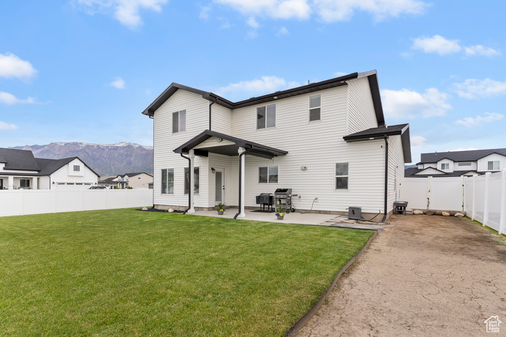 Back of house featuring a patio area and a mountain view