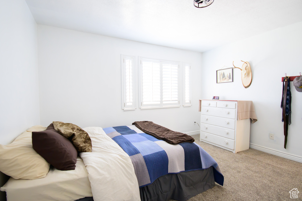 Bedroom with carpet and baseboards