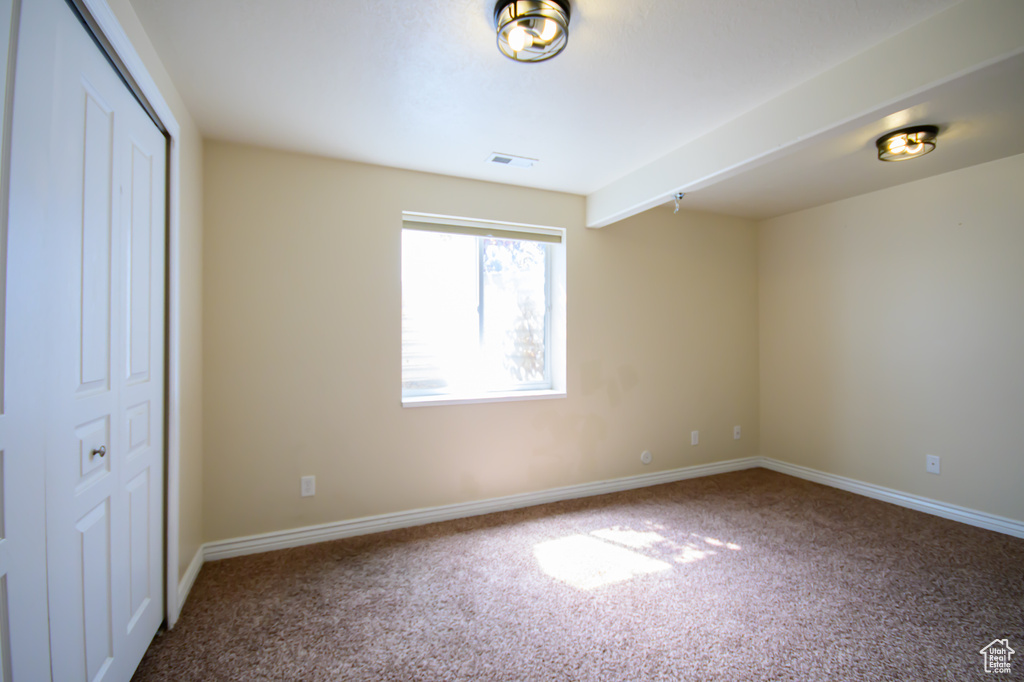 Unfurnished bedroom featuring carpet flooring, baseboards, and a closet