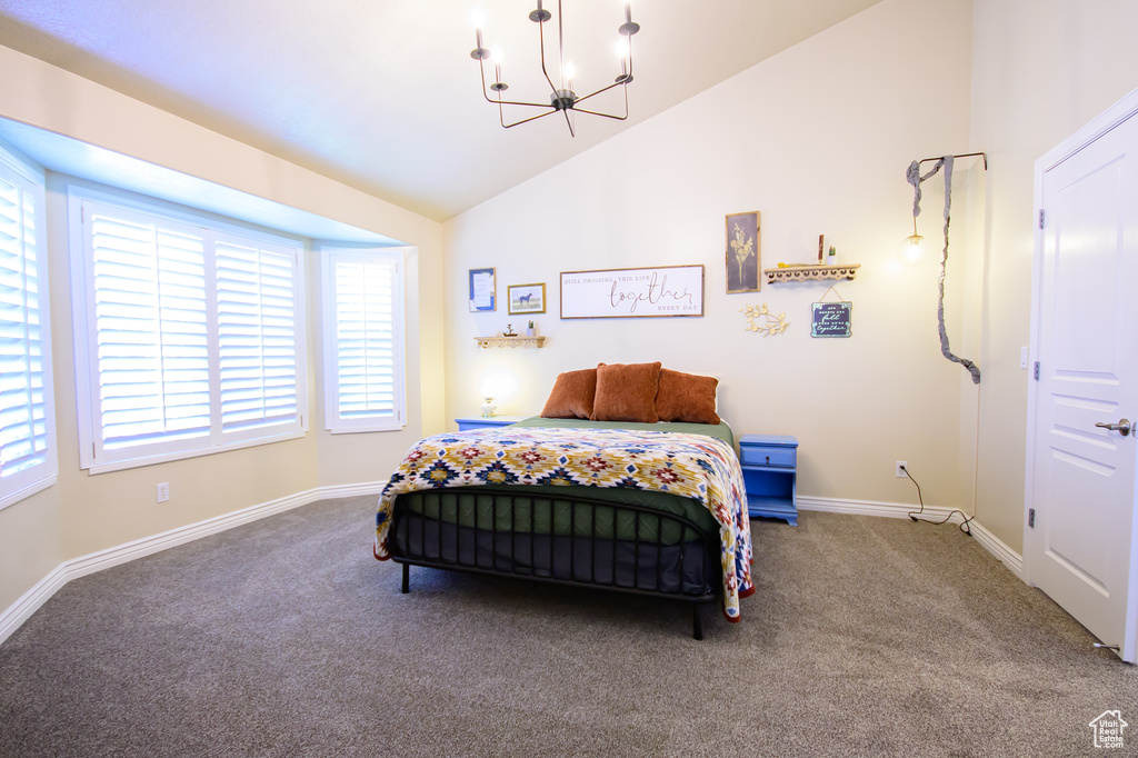 Bedroom featuring a chandelier, carpet, vaulted ceiling, and baseboards