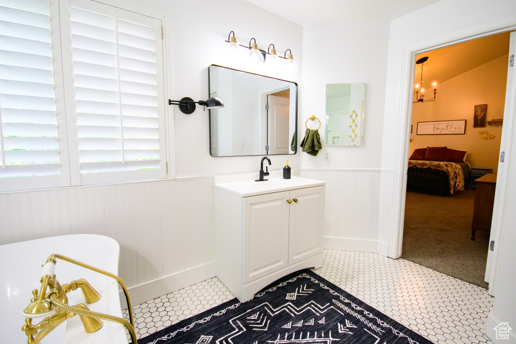 Bathroom featuring wainscoting, tile patterned floors, and vanity