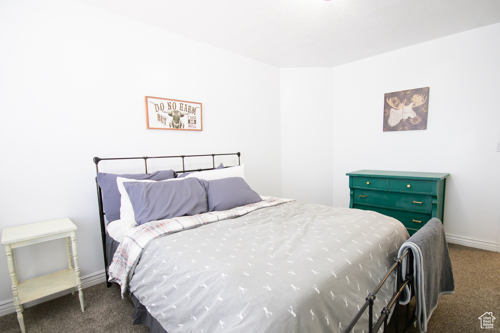 Bedroom featuring carpet flooring and baseboards