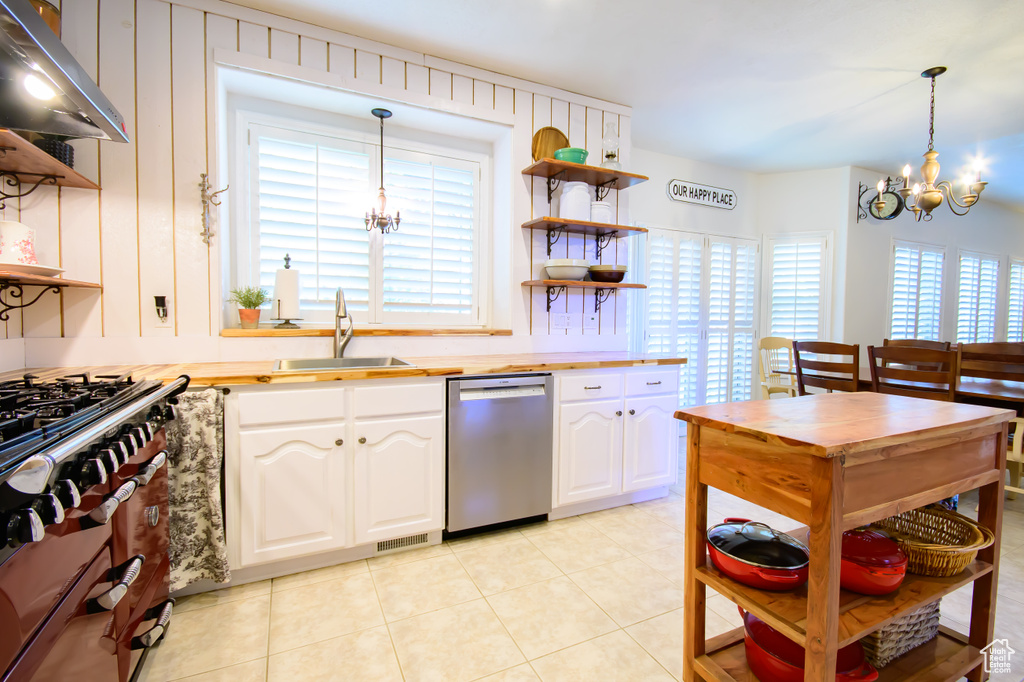 Kitchen featuring appliances with stainless steel finishes, a sink, open shelves, a chandelier, and range hood