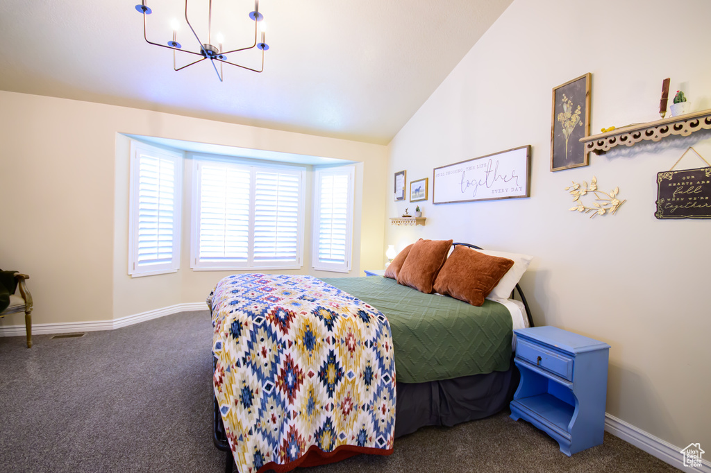 Carpeted bedroom featuring a chandelier, baseboards, and lofted ceiling