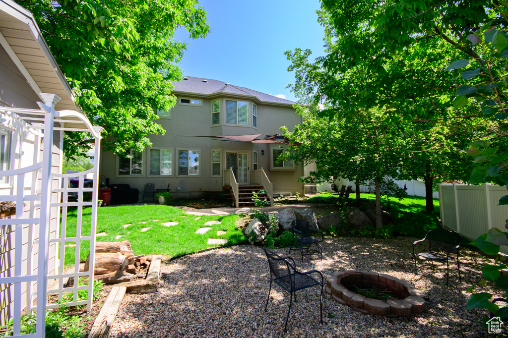 View of yard featuring a fire pit and entry steps