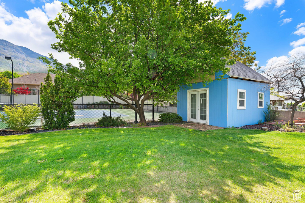 View of yard featuring french doors, a mountain view, and an outdoor structure