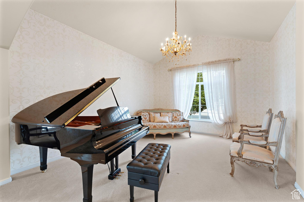 Sitting room featuring wallpapered walls, lofted ceiling, carpet, a chandelier, and baseboards