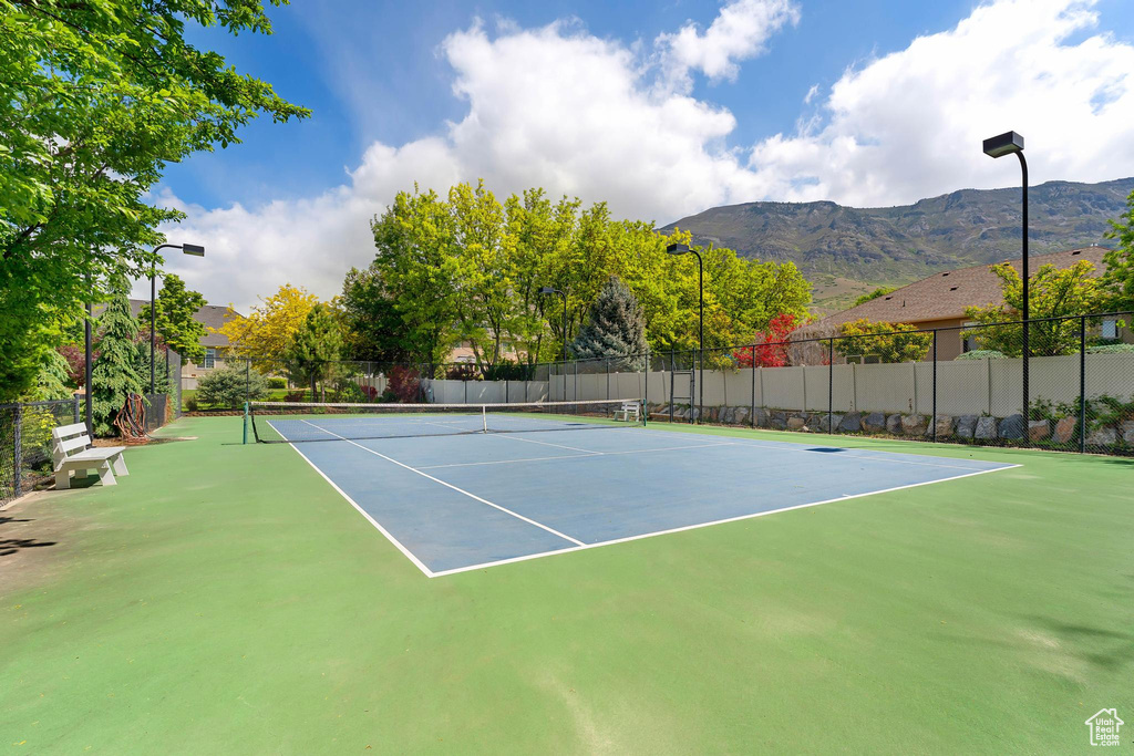 View of tennis court with a mountain view and community basketball court