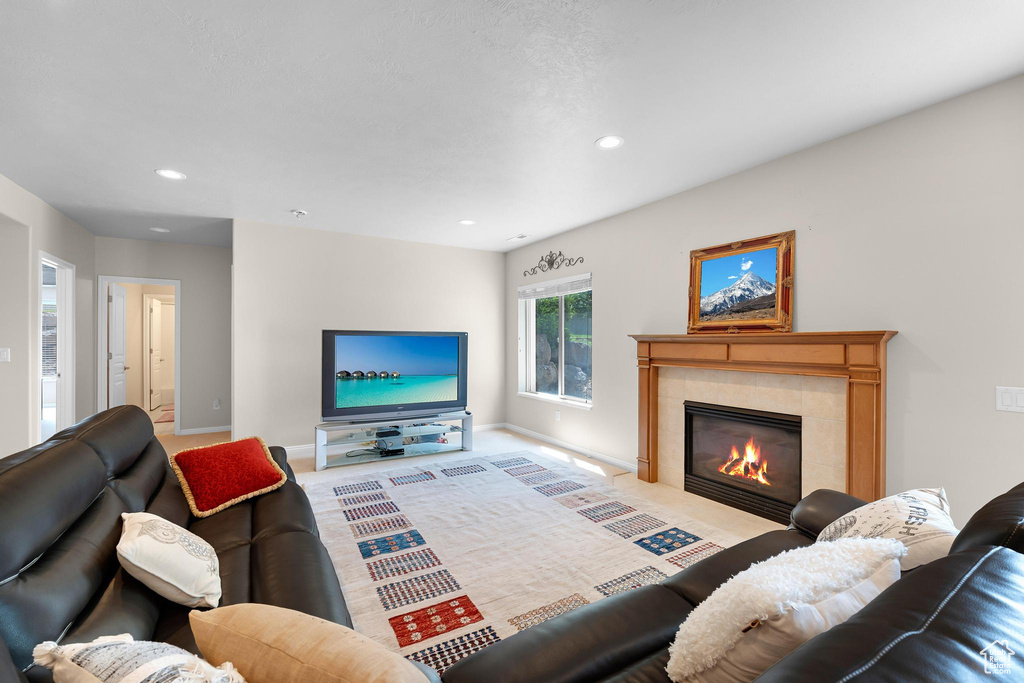 Living area featuring recessed lighting, baseboards, a fireplace, and carpet flooring